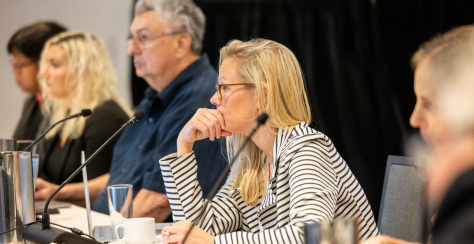Group of people working at a meeting with microphones